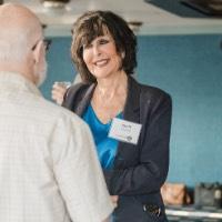 President Mantella smiling during conversation with older gentleman